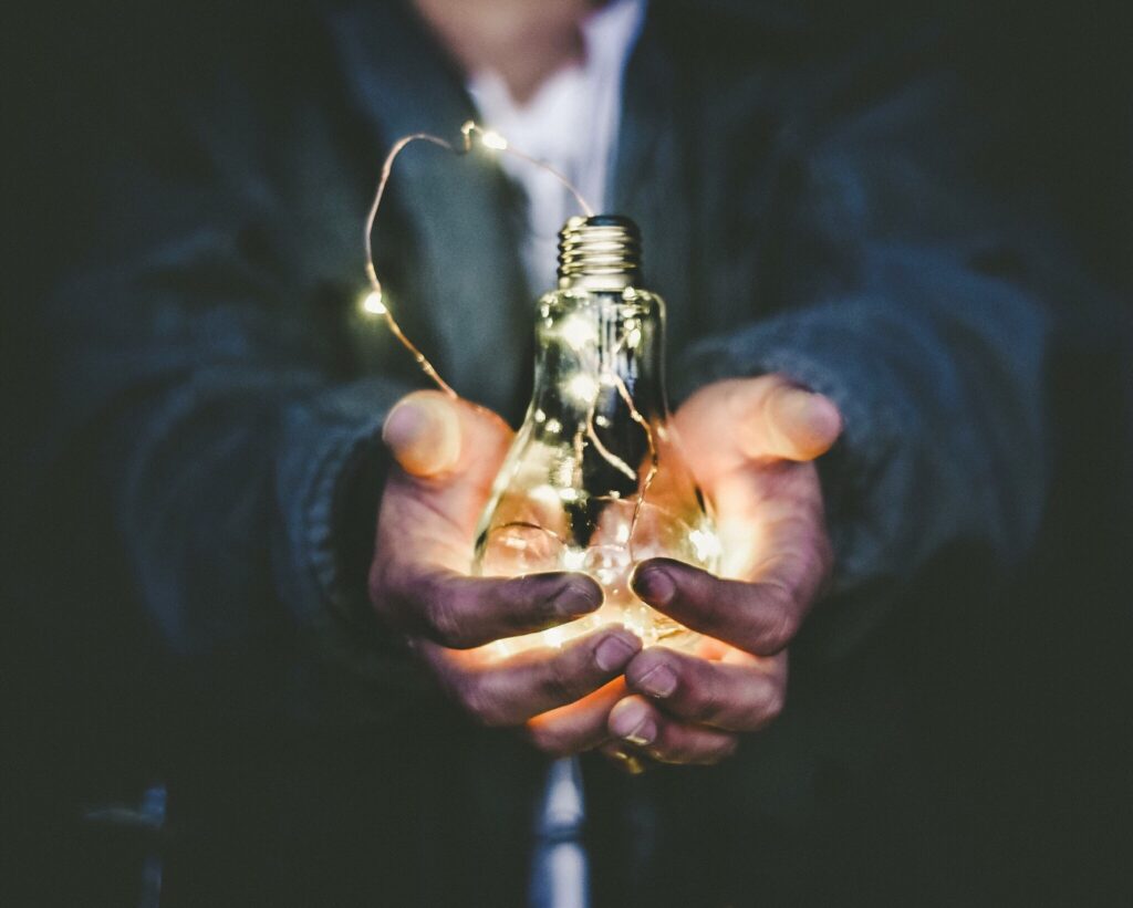 Man cradling a lightbulb in his hands